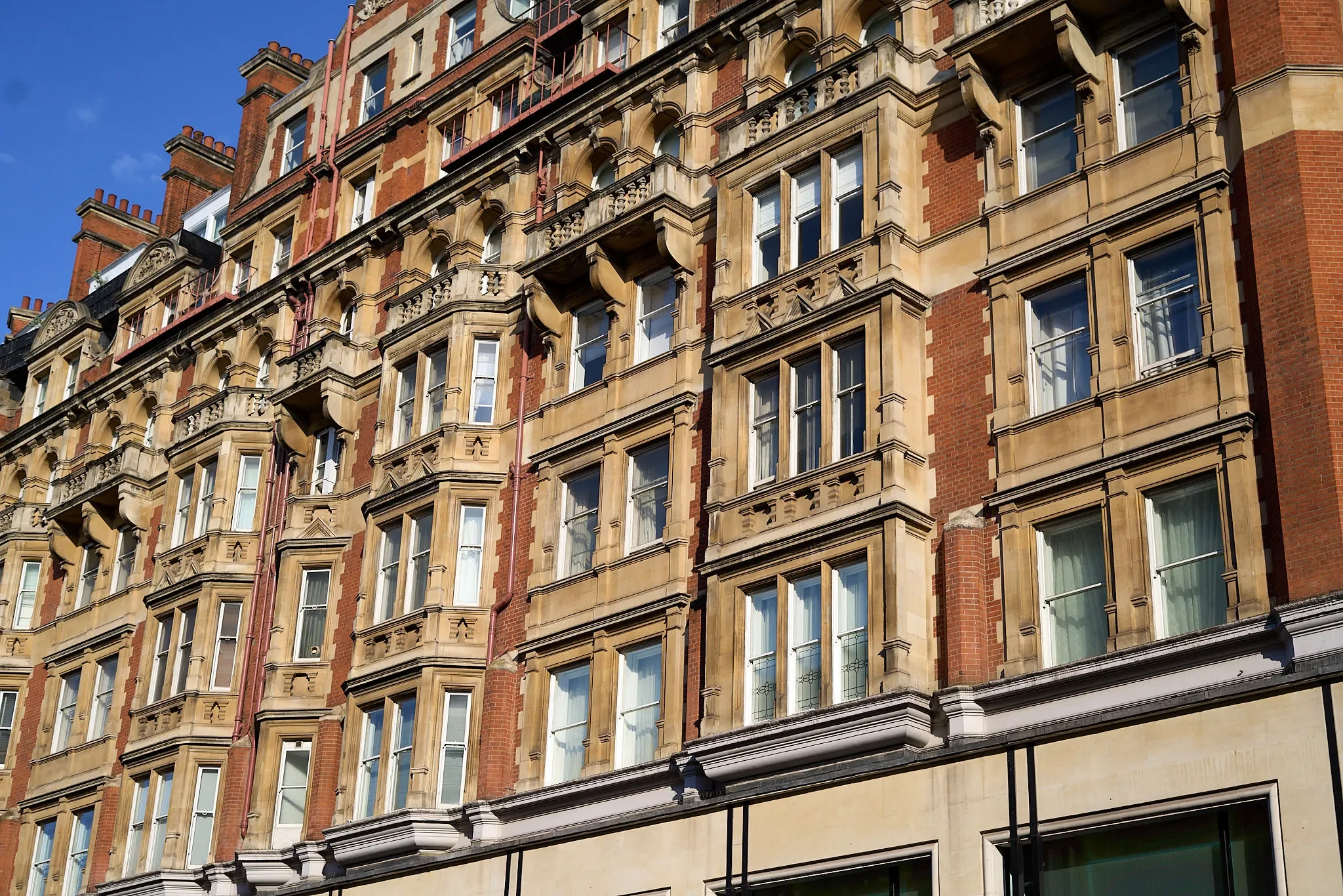 Ornate Victorian red-brick building facade with bay windows