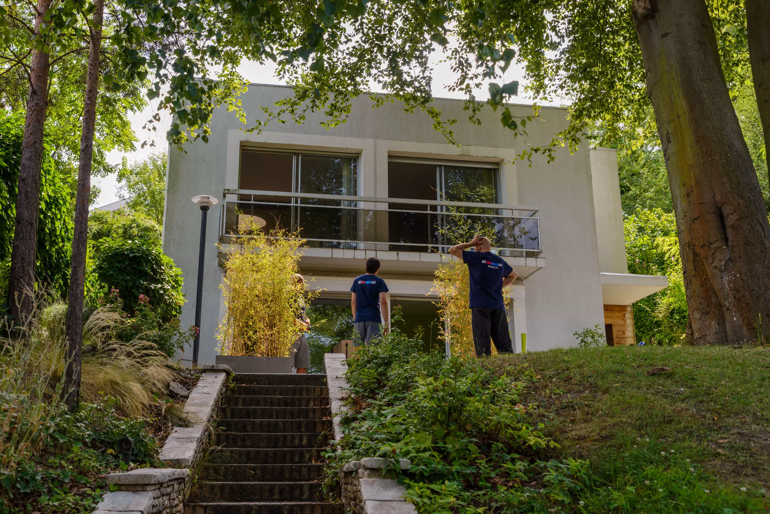 Removals team inspecting access to modern home in Brent before moving day.