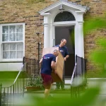 2 men team carring furniture