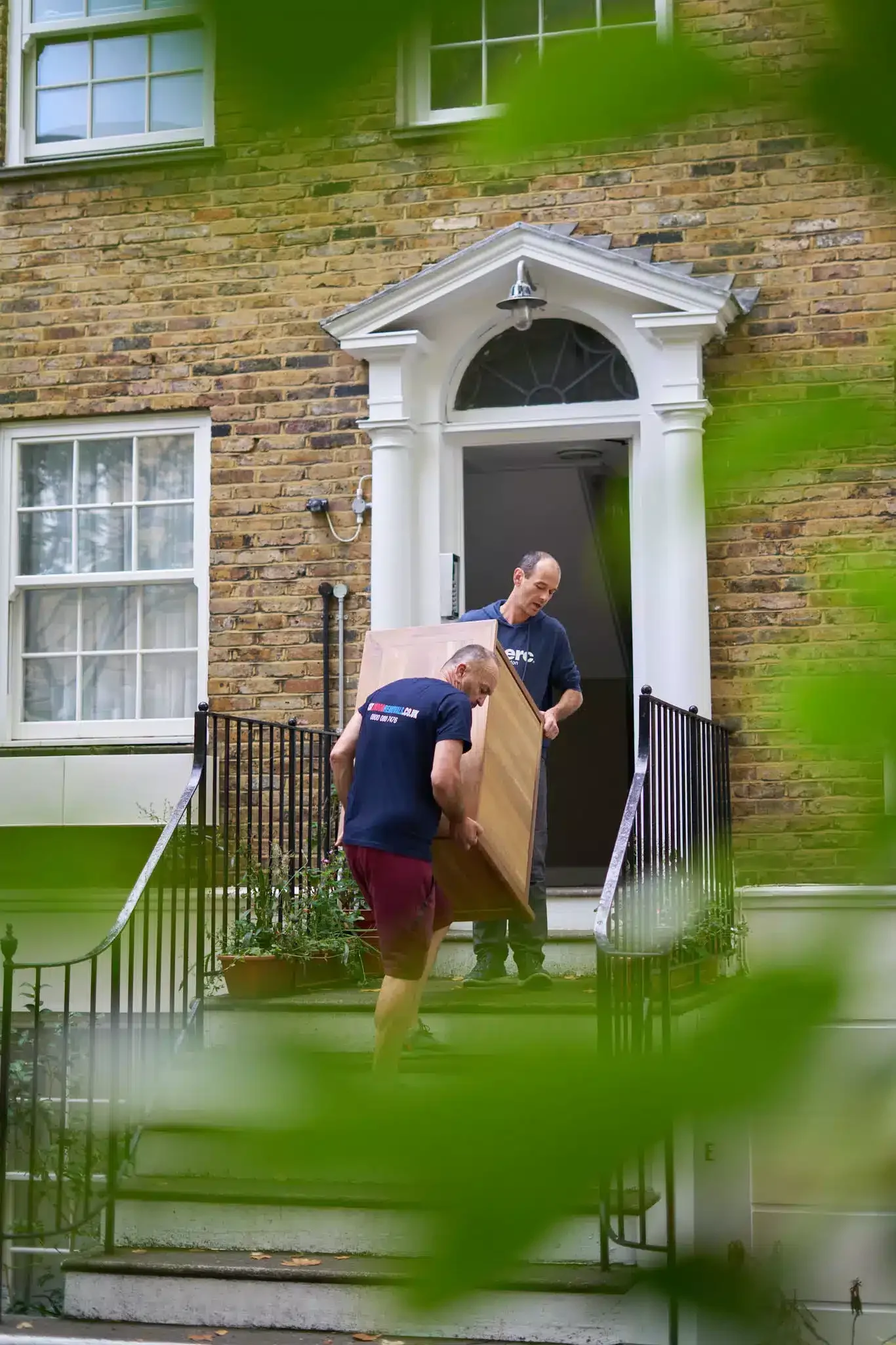2 men team carring furniture