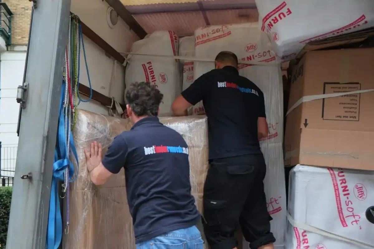 Best London Removals team loading protected furniture into a van during a house move.