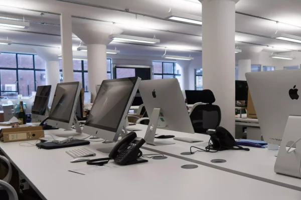 Modern office with computers and phones prepared for professional commercial relocation in London