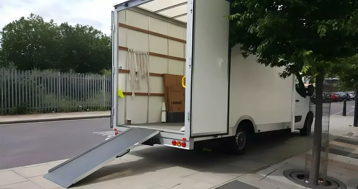 Man with a van London. Open removals van with ramp extended, parked kerbside and ready for loading.