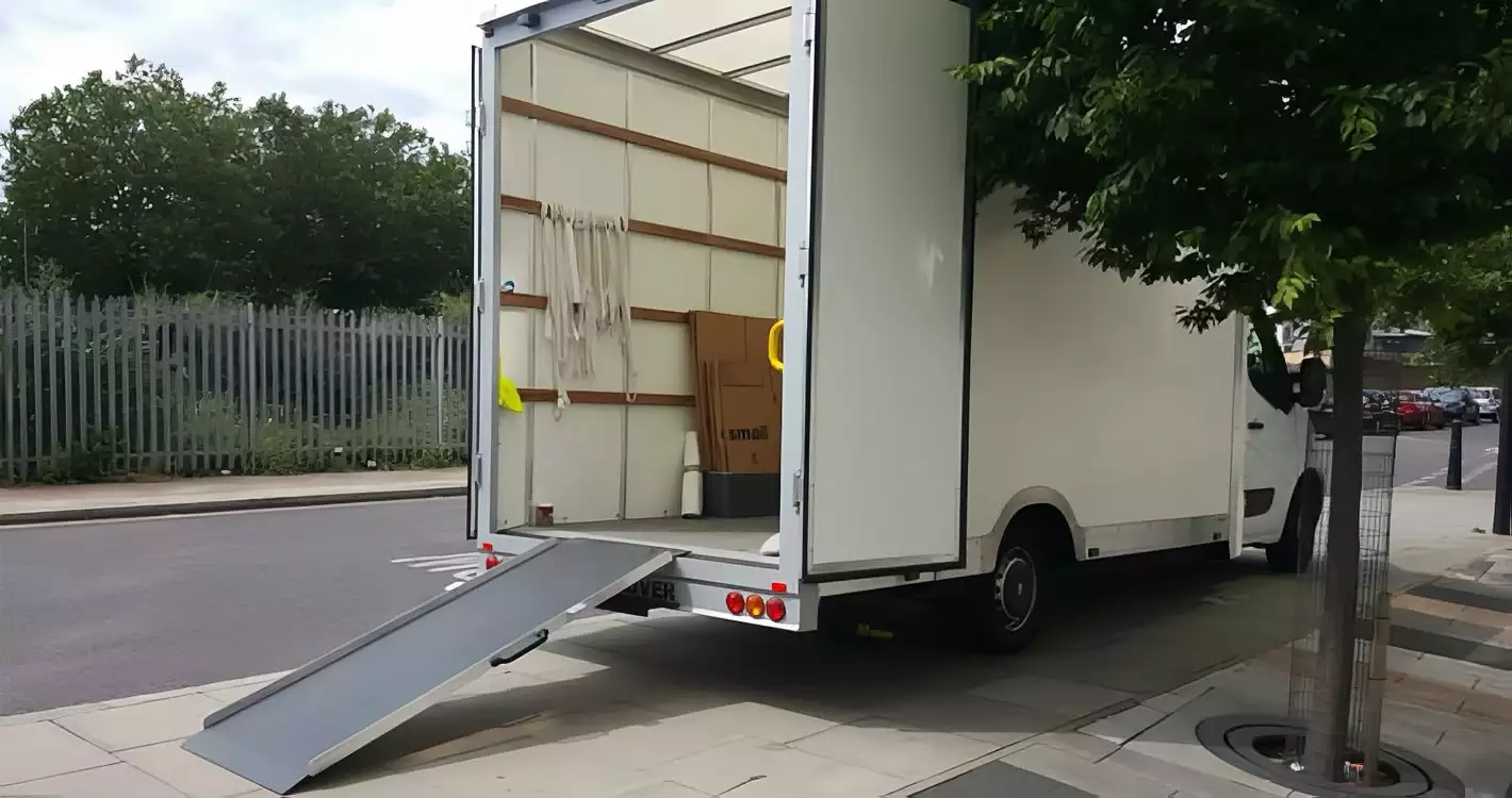 Man with a van London. Open removals van with ramp extended, parked kerbside and ready for loading.