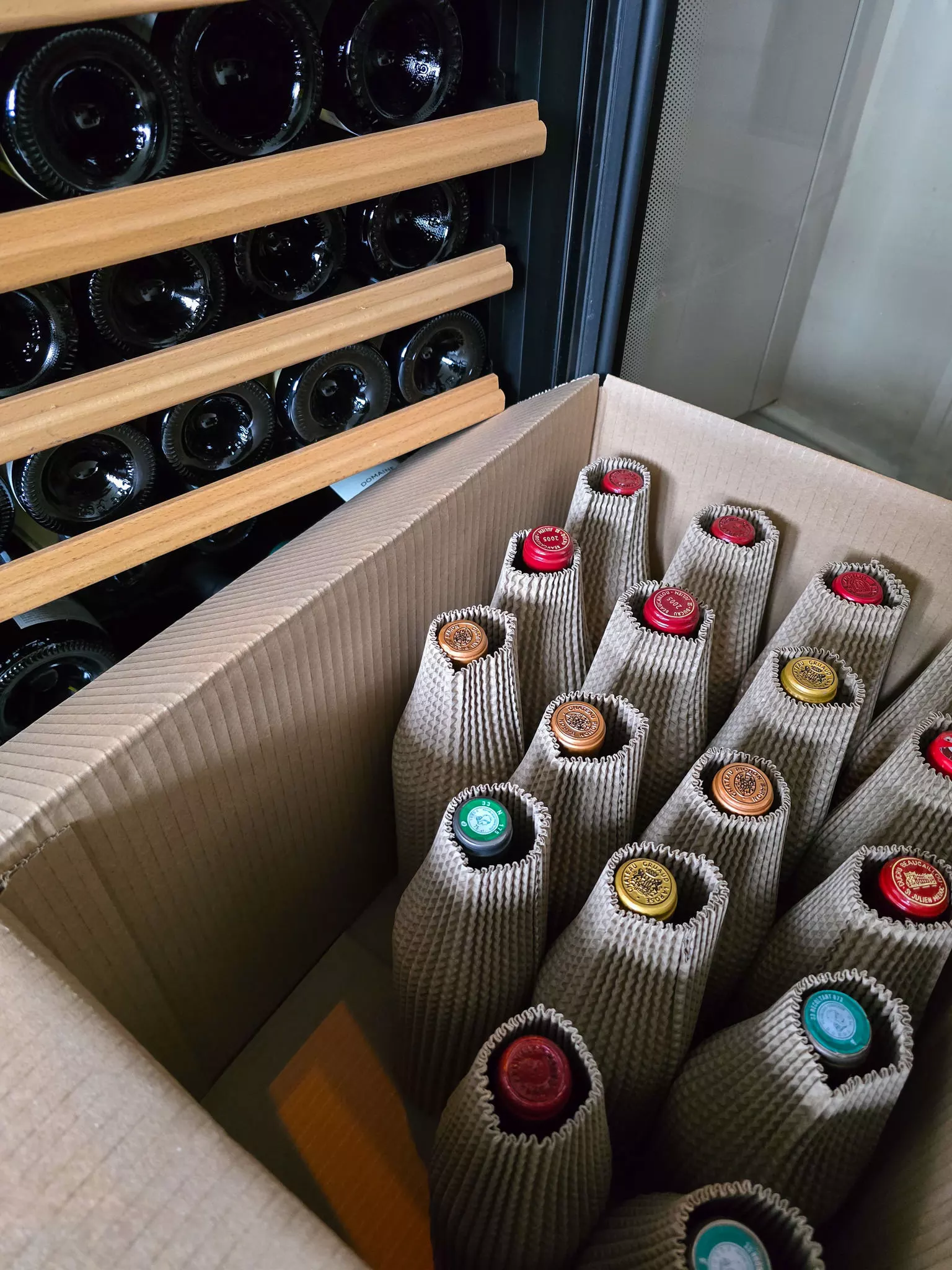 Cardboard box filled with individually wrapped wine bottles for safe transport