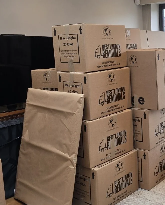 Stacked moving boxes labelled Best London Removals indoors