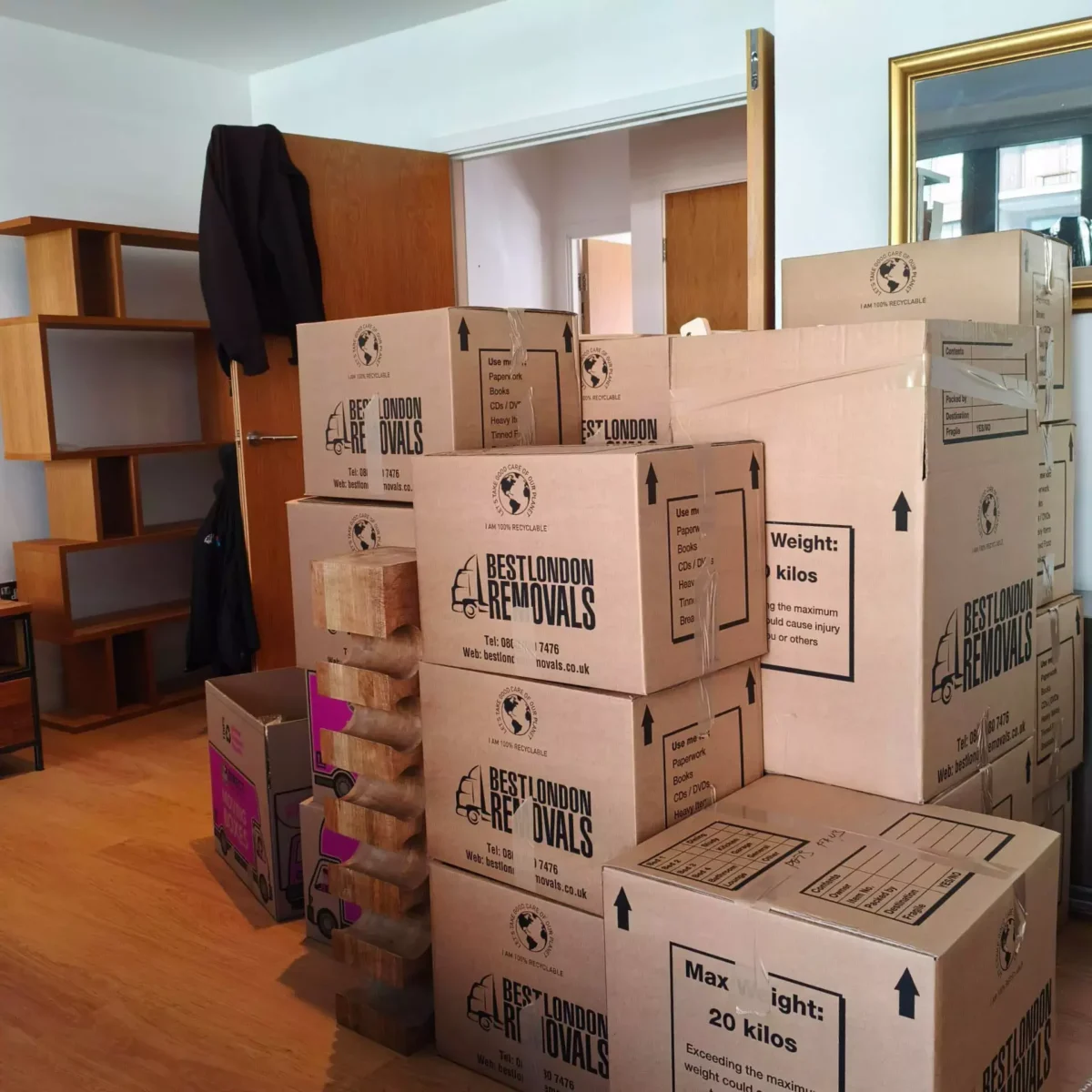Stacked Best London Removals boxes in a living room