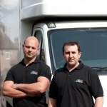 Two professional movers from Best London Removals standing in front of a removal van, ready for a Man and Van job.