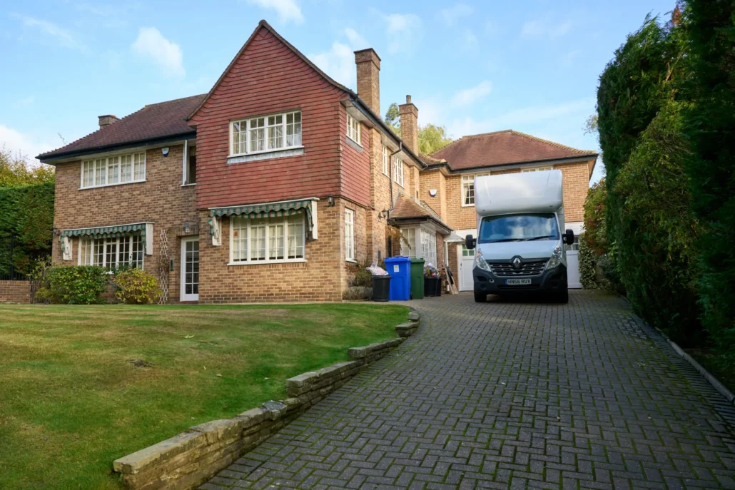 Best London Removals van parked on the driveway of a large detached family house