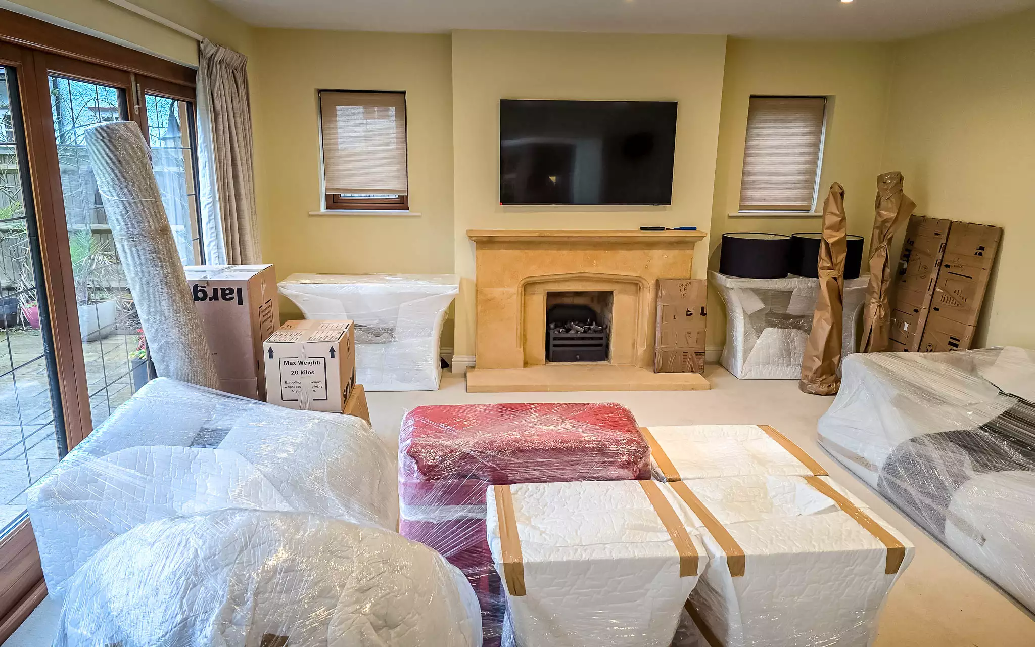 Living room packed and ready for removal Furniture packed with Furni-Soft padding and stretch wrap in a residential living room.