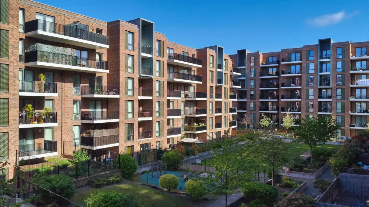 Modern brick apartment complex with balconies and communal gardens