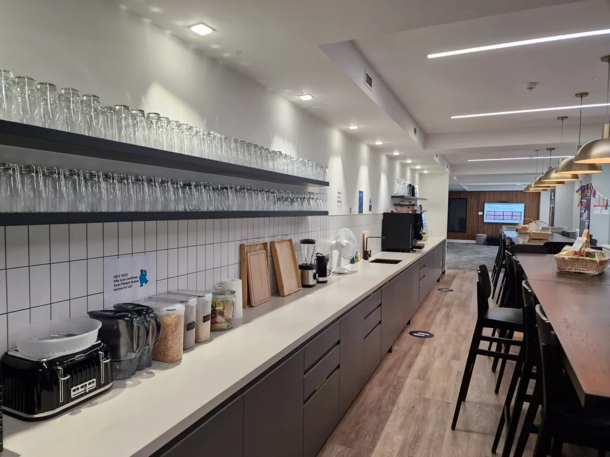 Modern office kitchen with shelves of glassware