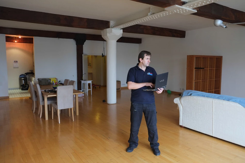 Moving estimator assessing contents of a partially packed home during moving quote visit