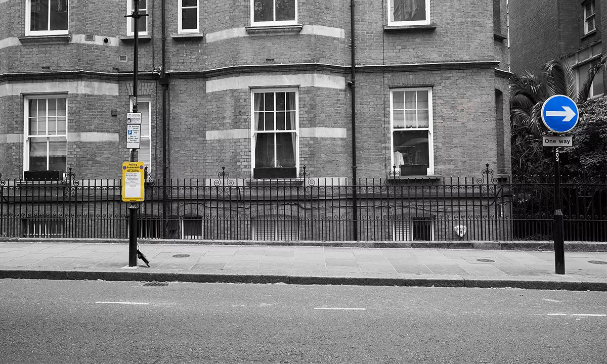 Parking suspension sign on a residential street in London, used to reserve space for removals or loading.