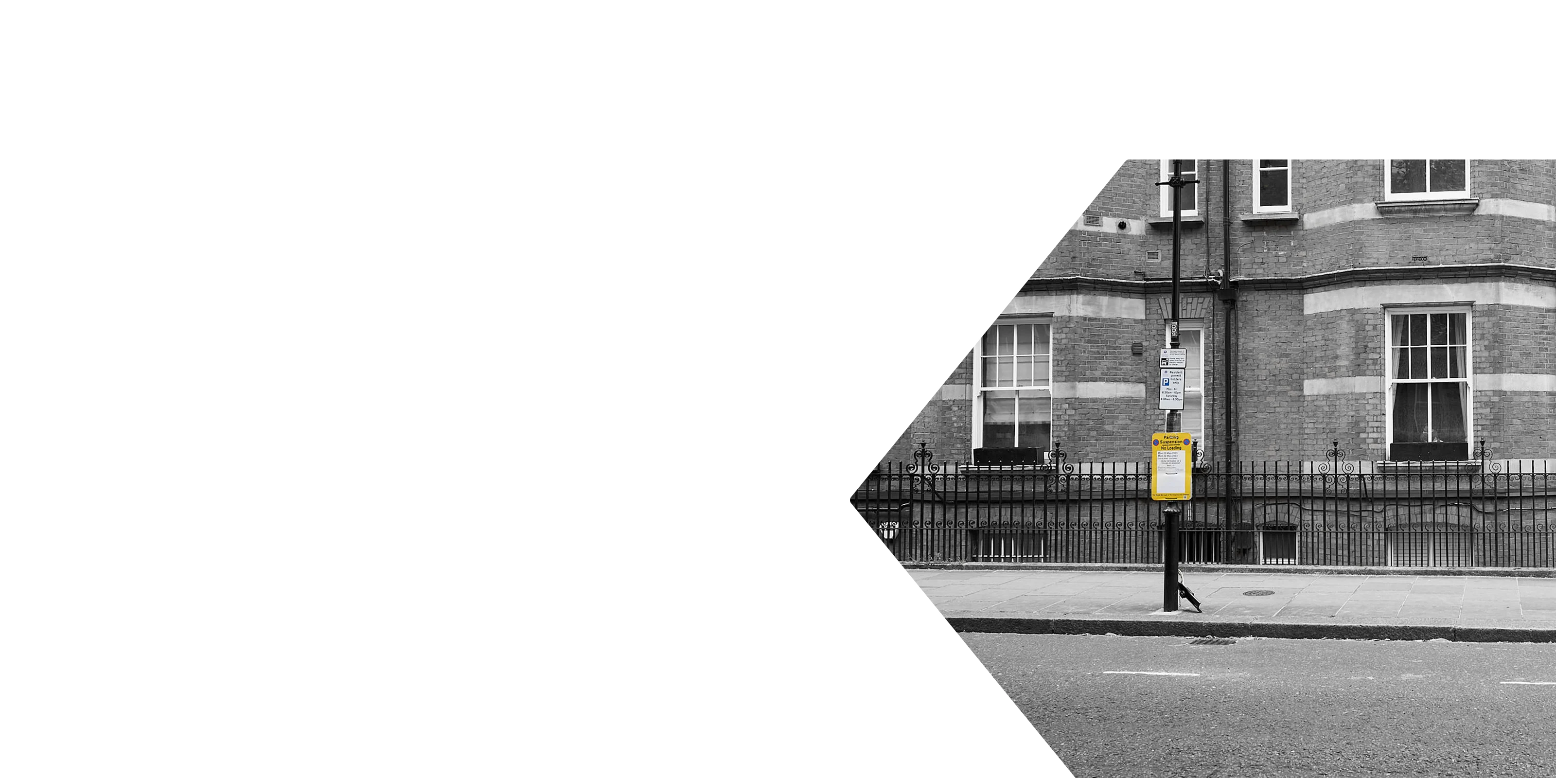 Parking suspension sign on a residential street in London, used to reserve space for removals or loading.