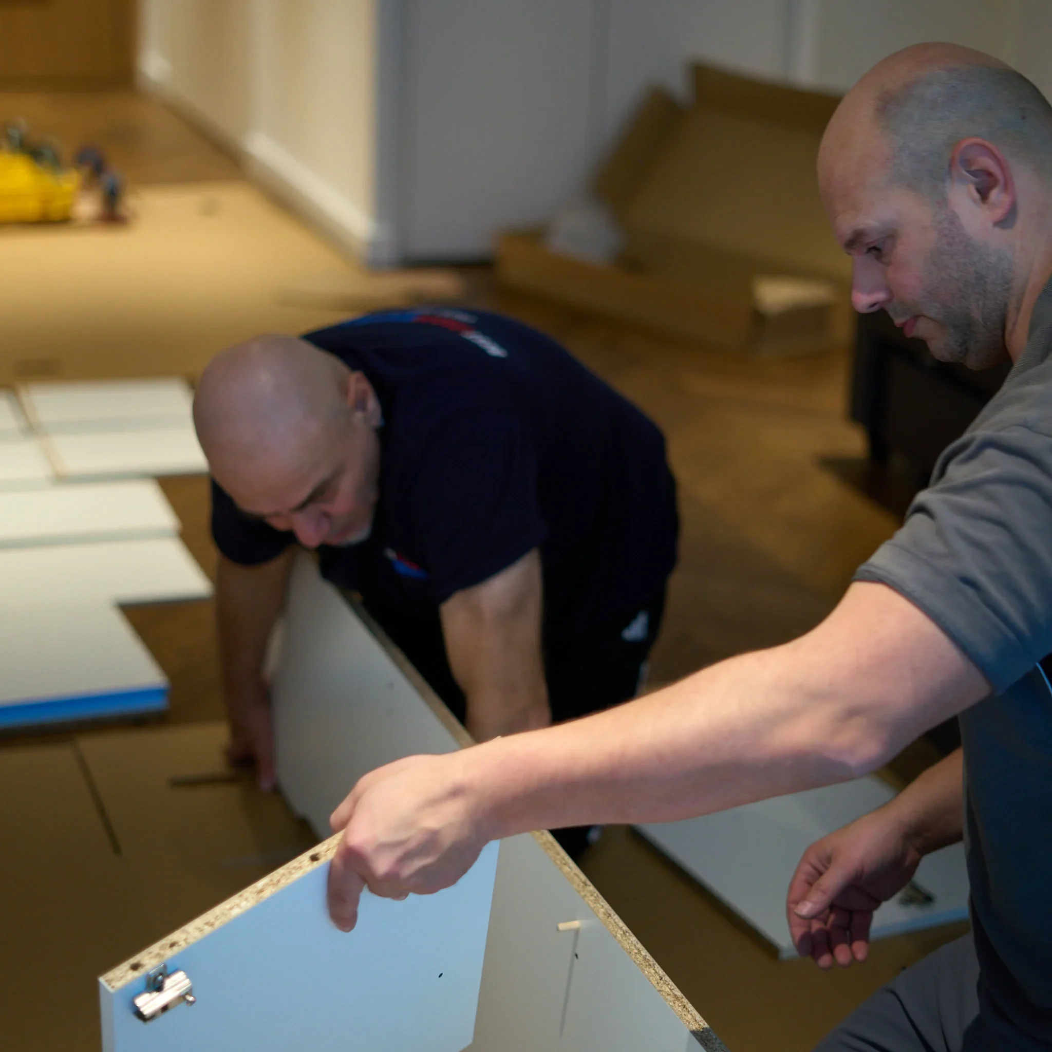 Team of Professionals Dismantling and Reassembling Flat-Pack Furniture 