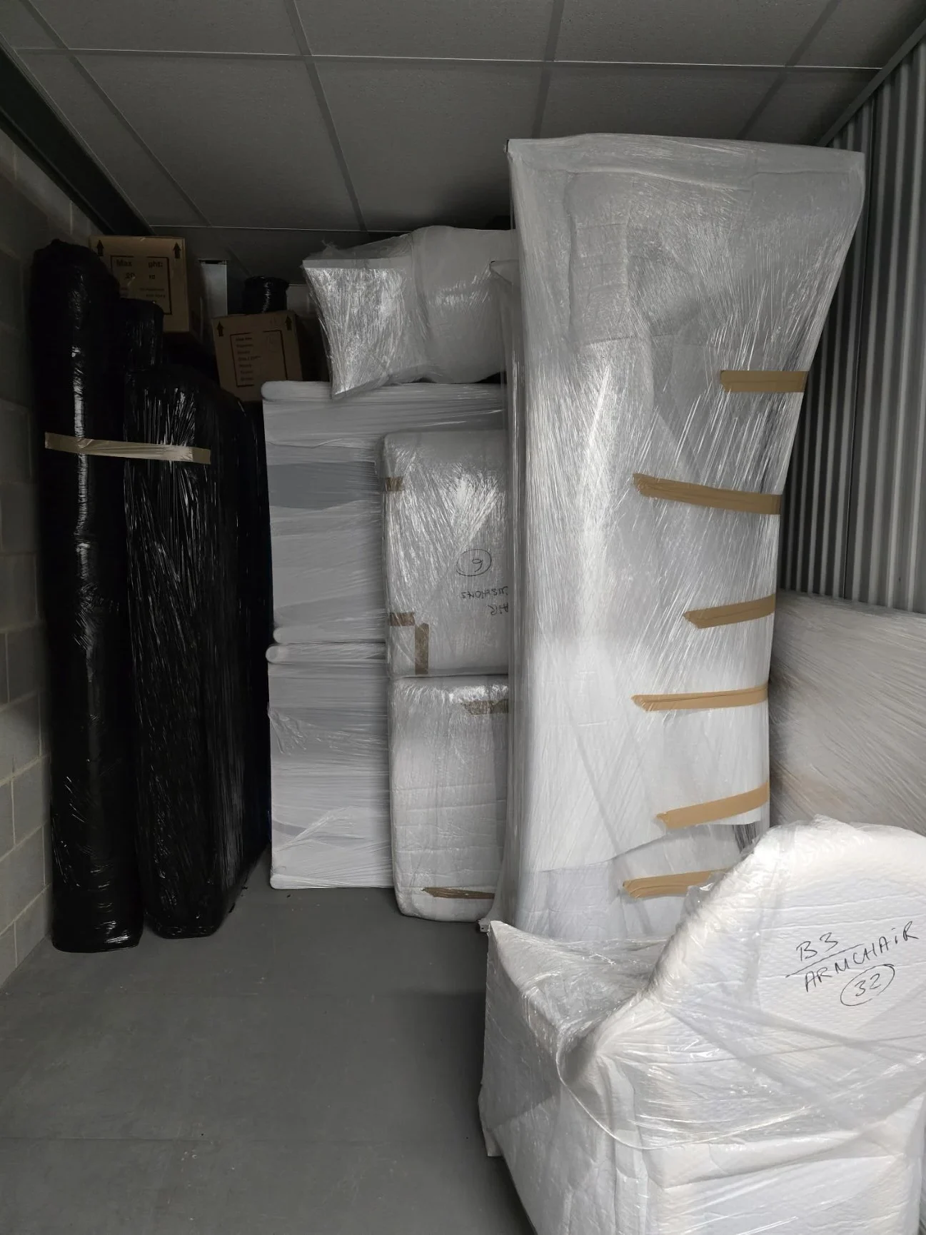Wrapped furniture stored inside a storage unit